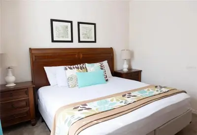 a bedroom with a large bed with two night stands at 3 Bedroom 2 Bathroom Lucaya Village 15-103 in Kissimmee