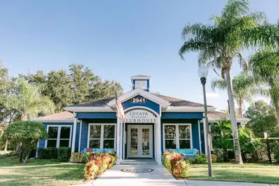 a blue building with a sign in front of it at 3 Bedroom 2 Bathroom Lucaya Village 15-103 in Kissimmee