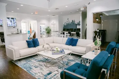 a living room with a white couch and blue chairs at 3 Bedroom 2 Bathroom Lucaya Village 15-103 in Kissimmee