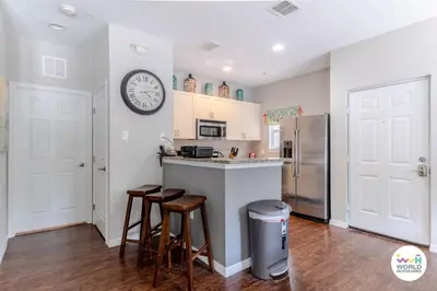 a kitchen with a counter and a clock on the wall at 4 Bedroom 3 Bathroom Lucaya Village 17-104 in Kissimmee