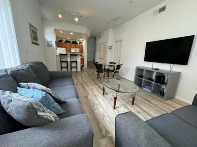 a living room with a couch and a flat screen tv at 4 Bedroom 3 Bathroom Villas At Seven Dwarfs 8-107 in Kissimmee