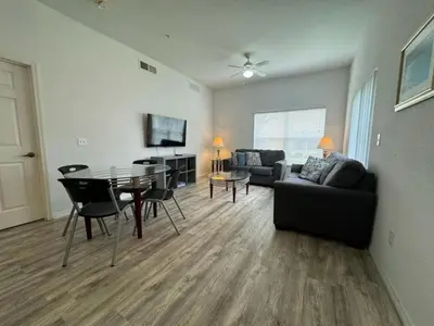 a living room with a table and a couch at 4 Bedroom 3 Bathroom Villas At Seven Dwarfs 8-107 in Kissimmee