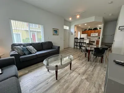 a living room with a couch and a table at 4 Bedroom 3 Bathroom Villas At Seven Dwarfs 8-107 in Kissimmee