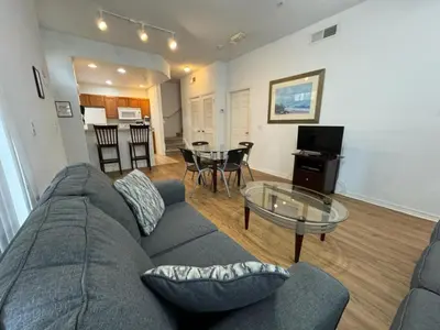 a living room with a couch and a glass table at 4 Bedroom 3 Bathroom Villas At Seven Dwarfs 10-102 in Kissimmee