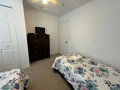 a bedroom with a bed and a dresser at 4 Bedroom 3 Bathroom Villas At Seven Dwarfs 10-102 in Kissimmee