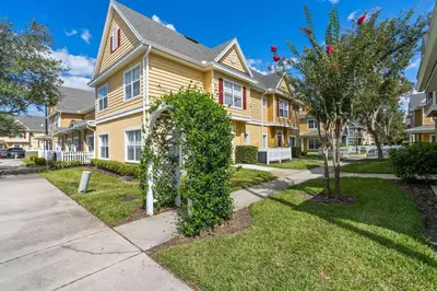 a yellow house with an ivy sign in front of it at 4 Bedroom 3 Bathroom Villas At Seven Dwarfs 24-102 in Kissimmee