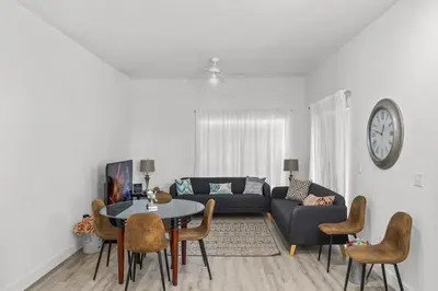 a living room with a couch and a table and chairs at 4 Bedroom 3 Bathroom Villas At Seven Dwarfs 24-102 in Kissimmee