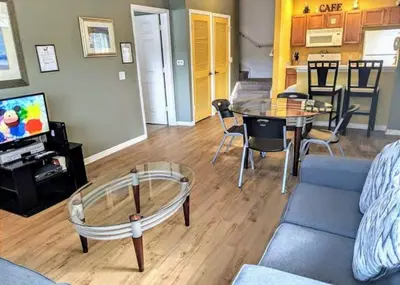 a living room with a couch and a table at 4 Bedroom 3 Bathroom Villas At Seven Dwarfs 1-101 in Kissimmee