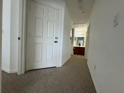 an empty hallway with a white door in a room at 4 Bedroom 3 Bathroom Villas At Seven Dwarfs 1-101 in Kissimmee