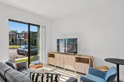 a living room with a couch and a tv at 3 Bedroom 3 Bathroom The Hub At Westside Reserve 3300 TT in Kissimmee