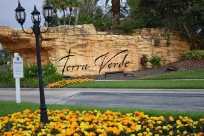 a street light in front of a wall with flowers at 3 Bedroom 3 Bathroom Terra Verde 4766 in Kissimmee