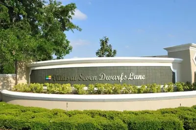 a sign for the school of sugar davis lane at 4 Bedroom 3 Bathroom Villas At Seven Dwarfs 8-108 in Kissimmee