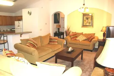 a living room with two couches and a table at 4 Bedroom Value Plus Home with Private PooI in Orlando