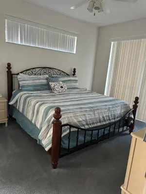 a bedroom with a large bed with a wooden frame at Shrek's Hideout! - 5 min from Disney! in Kissimmee