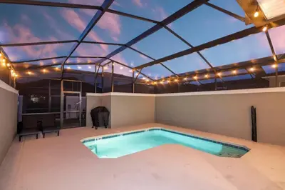a swimming pool in a house with a roof at Condominium villas near Disney Orlando Florida in Kissimmee