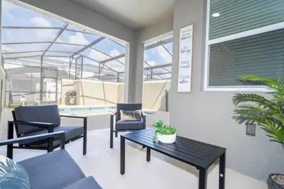 a patio with a table and chairs and a pool at Condominium villas near Disney Orlando Florida in Kissimmee