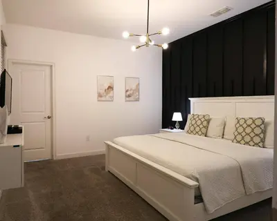 a bedroom with a large bed with a black headboard at Themed 5BD Home Movie and Game Room 4726 in Kissimmee