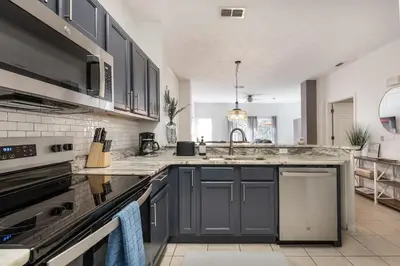 a kitchen with a sink and a counter top at Stay Close to Disney in Your 3-Bedroom Haven in Kissimmee