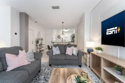 a living room with two couches and a flat screen tv at Stay Close to Disney in Your 3-Bedroom Haven in Kissimmee