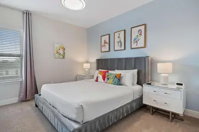 a bedroom with a large white bed and a window at 7410 Marker Avenue in Orlando