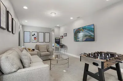 a living room with a couch and a game table at 7410 Marker Avenue in Orlando