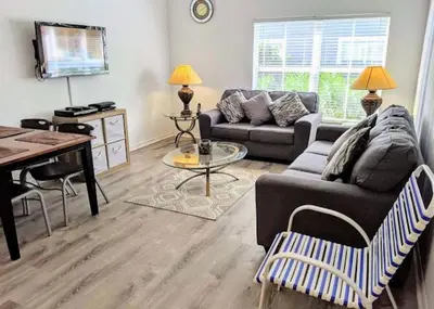 a living room with a couch and a table at 4 Bedroom 3 Bathroom Villas At Seven Dwarfs 17-107 in Kissimmee