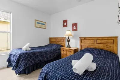 a bedroom with two beds with towels on them at 161 - 4 bed Gem at Terraverde Resort in Kissimmee