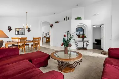 a living room with a red couch and a table at 161 - 4 bed Gem at Terraverde Resort in Kissimmee
