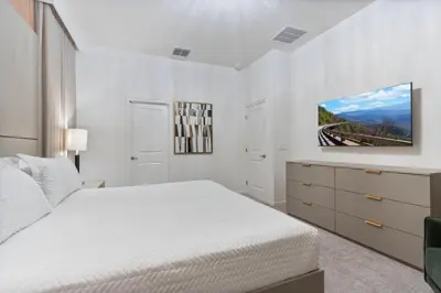 a white bedroom with a bed and a dresser at Brand NEW 12Bedrooms12Bathroom At Paradiso Grande in Orlando