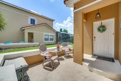 a patio with chairs and a white door at 7 Mi to Disney Kissimmee Poolside Paradise! in Kissimmee