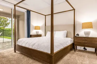 a bedroom with a canopy bed and a dresser and lamps at Your Dream Vacation Awaits Family 10-Bd Villa in Orlando