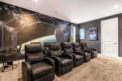 a room with a movie theater with a star wars mural at Your Dream Vacation Awaits Family 10-Bd Villa in Orlando