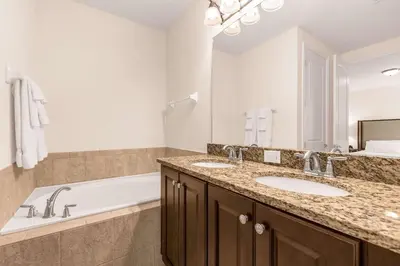 a bathroom with two sinks and a bath tub at Your Dream Vacation Awaits Family 10-Bd Villa in Orlando