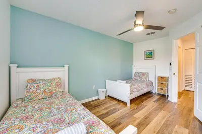 a bedroom with a bed and a crib at Private Pool Family-Friendly Kissimmee Townhome! in Kissimmee