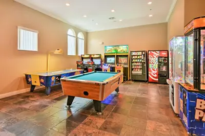 a game room with two pool tables and arcade machines at Private Pool Family-Friendly Kissimmee Townhome! in Kissimmee