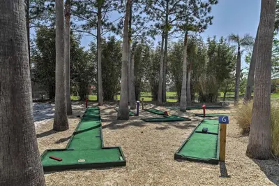a playground with green trampolines and trees at Private Pool Family-Friendly Kissimmee Townhome! in Kissimmee