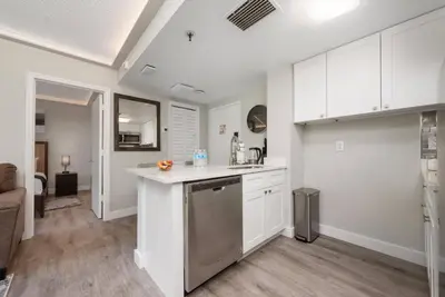a kitchen with white cabinets and a counter top at 2 Suites at The Enclave Near Universal in Orlando