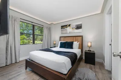a bedroom with a large bed and a window at 2 Suites at The Enclave Near Universal in Orlando