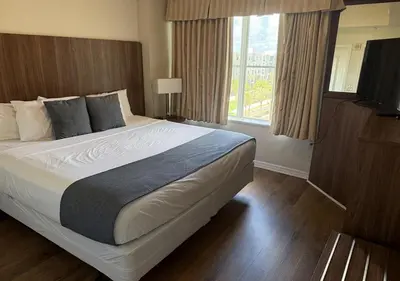 a bedroom with a large bed and a window at The Point Hotel Apartment 603 Near to Universal in Orlando