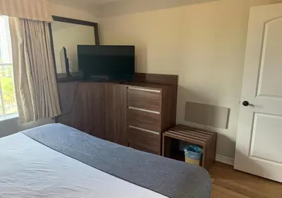 a bedroom with a bed and a flat screen tv at The Point Hotel Apartment 603 Near to Universal in Orlando
