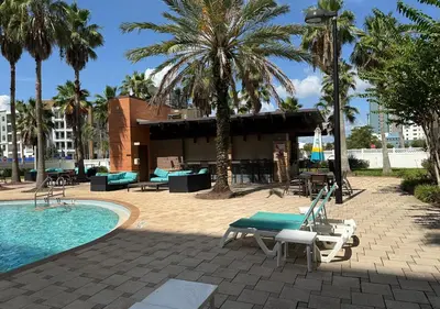 a resort with a swimming pool and palm trees at The Point Hotel Apartment 603 Near to Universal in Orlando