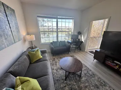 a living room with a couch and a flat screen tv at WH7660-205CS - Lakeview on the hills in Orlando