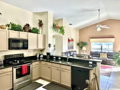 a kitchen with a sink and a stove top oven at EP1015SEL - 4 bedrooms - 8 guests pool home on a lake in Kissimmee