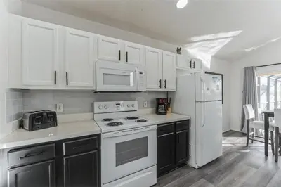 a kitchen with white cabinets and white appliances at 637- Huge 5 Bed Villa with Amazing Water Views and Own Private Pool and Spa in Kissimmee