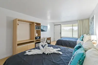 a hotel room with two beds with towels on the bed at 11 Condo-Hotel With Double Bed And Community Pool Miles From Disney! in Kissimmee