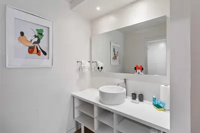 a white bathroom with a sink and a mirror at 11 Condo-Hotel With Double Bed And Community Pool Miles From Disney! in Kissimmee