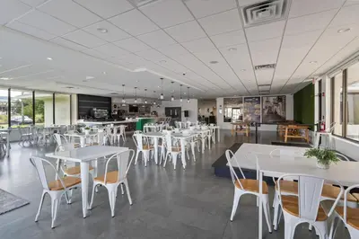 a dining room with white tables and chairs at 11 Condo-Hotel With Double Bed And Community Pool Miles From Disney! in Kissimmee