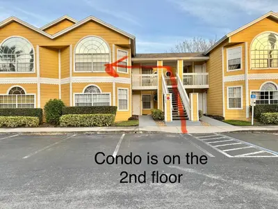 a house with a red ribbon in front of it at Spacious Condo Close to Disney Attractions in Kissimmee