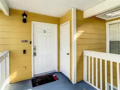 a house with a white door and a porch at Spacious Condo Close to Disney Attractions in Kissimmee