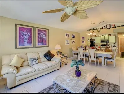 a living room with a couch and a dining room at Spacious Condo Close to Disney Attractions in Kissimmee